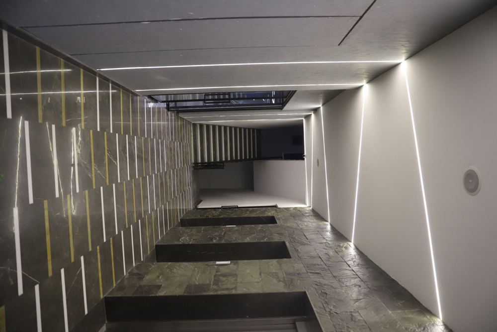 Corridor lit by angled linear light slits