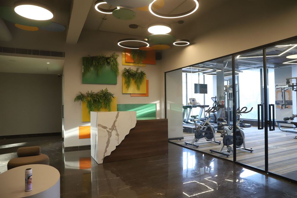 Fitness reception with living green walls and circular lights