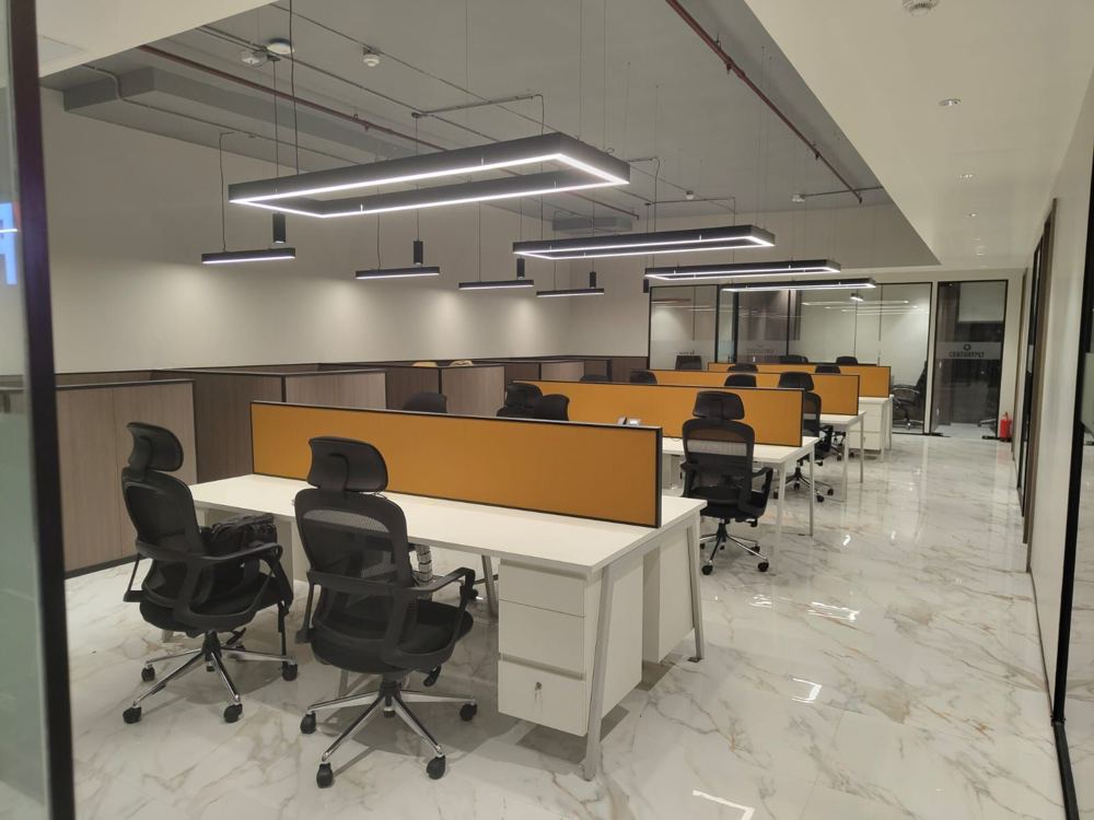 Workstation bay with marble flooring and suspended light frames